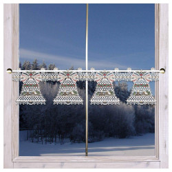 Vor einem Fenster hängt ein dekorativer Spitzenvorhang mit Glöckchenmuster. Durch das Fenster ist eine verschneite Landschaft mit frostbedeckten Bäumen unter einem bewölkten Himmel sichtbar.