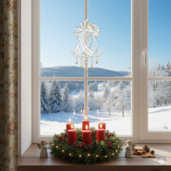 Ein festlicher Kranz mit vier roten Kerzen und kleinen Engelsfiguren steht auf einer Fensterbank, umrahmt von einer verschneiten Landschaft draußen. Eine zarte Plauener Spitze Fensterbild Glockenspiel hängt im Fenster und unterstreicht das festliche Motiv.