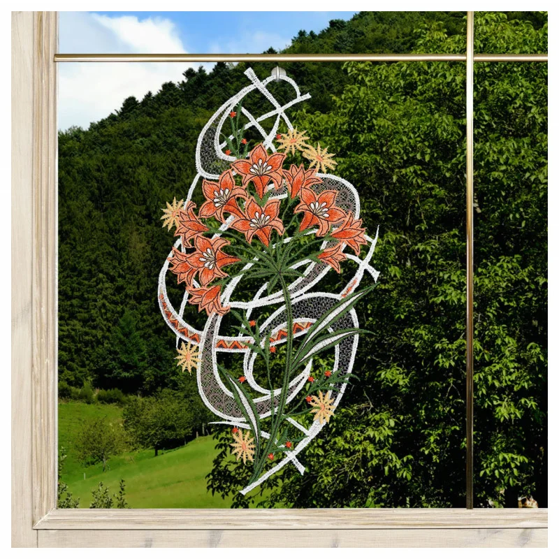 Ein Fensterrahmen mit Blick auf einen dichten grünen Wald. Das Fensterglas zeigt ein kompliziertes Muster aus orangefarbenen Lilien mit grünen Stängeln und Blättern, die mit weißen geometrischen, spitzenartigen Mustern vor dem natürlichen Hintergrund verflochten sind.